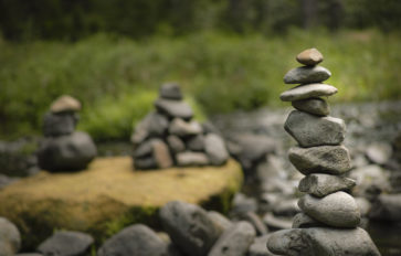 A pile of rocks near a stream.