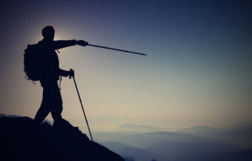 Hikers looking out over the edge of a mountain