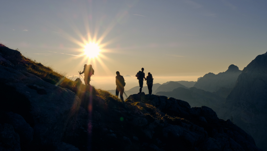 People hiking during sunset.